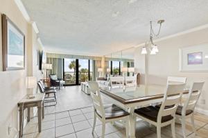 a dining room and living room with a table and chairs at 2-Bedroom Carolina Dunes Condo with Private Balcony and Ocean Views in Myrtle Beach