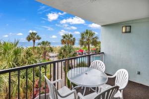 a balcony with a table and chairs and the ocean at 2-Bedroom Carolina Dunes Condo with Private Balcony and Ocean Views in Myrtle Beach +22 photos