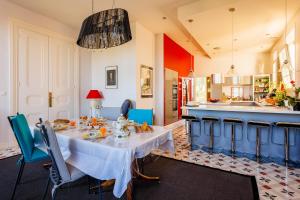 a dining room with a table and a kitchen at La Passerelle du Canal in Sallèles-dʼAude