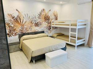 a bedroom with a bed and a bunk bed and a shelf at B&B Birillo in Cariati
