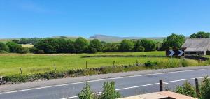 a road with a sign on the side of the road at Rucastle Apartment in Ingleton