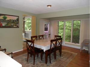 a dining room with a table and chairs at Pinebrook - Three Bedroom House in Lake George