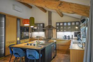 a kitchen with wooden cabinets and a wooden table at Domaine Les Mésanges in Saint-Tropez
