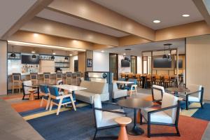 a restaurant with tables and chairs and a bar at Hyatt House Rochester Mayo Clinic Area in Rochester