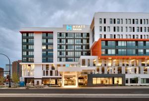 a large white building with a sign on it at Hyatt House Rochester Mayo Clinic Area in Rochester
