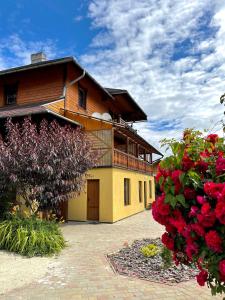 a large house with red flowers in front of it at Садиба "ЯНА" in Slavske