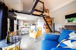a living room with a blue couch and a table at K-Jol et Vous in Aywaille