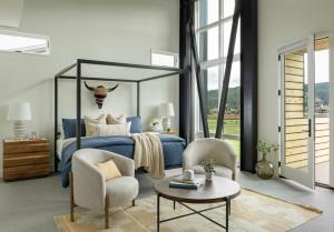 a bedroom with a blue bed and a table and chairs at Fairways #2 in Big Sky