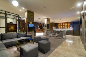 a lobby with a couch and chairs and a table at Oca Oriental Porto Hotel in Porto