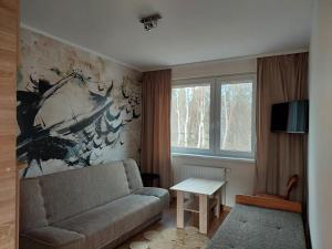 a living room with a couch and a table at Belona in Stegna