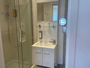 a bathroom with a sink and a shower at Hôtel Le Méditerranée in Hyères