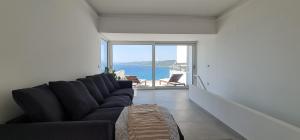a living room with a couch and a view of the ocean at Bona Vitae - Attico Vista Mare Castro in Castro di Lecce +16 photos