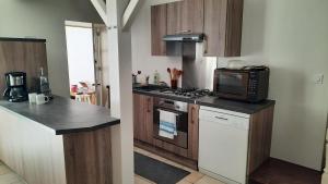 a kitchen with a microwave and a stove top oven at Maison de pêcheur rénovée avec cour proche du port in Les Sables-dʼOlonne +15 photos