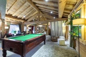 a large room with a pool table in it at Residence Les Fermes du Soleil - maeva Home in Les Carroz d'Araches