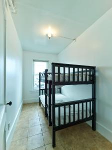 two bunk beds in a room with a window at 7 Beachside inn in Hampton