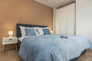 a bedroom with a blue bed with a blue comforter at Villa El Istria Rabac- Private Pool & BBQ in Labin +62 photos