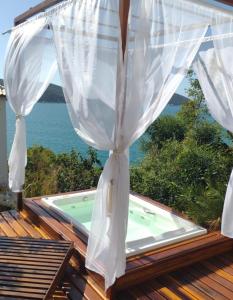 a view from the deck of a house with a pool at Casa Corazul in Arraial do Cabo