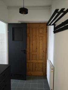a hallway with a wooden door in a room at A summer house Zarabie Domek letniskowy Zarabie in Myślenice