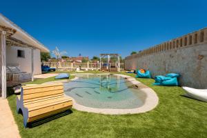a backyard with a pool with a bench and a playground at Don Leonardo - pool and wellness in Polignano a Mare