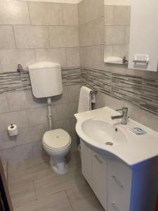 a bathroom with a toilet and a sink at Hotel Giulietta e Romeo in Casal Palocco