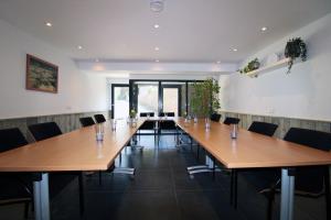 a conference room with wooden tables and chairs at Het Dijkje Utrecht in Utrecht