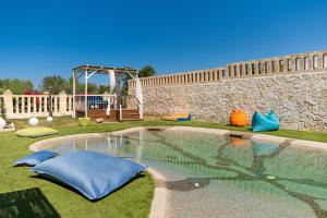 a swimming pool in a yard with a playground at Don Leonardo - pool and wellness in Polignano a Mare