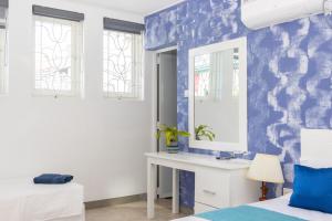 a bedroom with a blue and white wall at Bohemian Villa - Negombo in Negombo