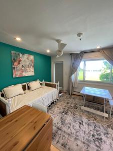 a bedroom with two beds and a table in it at The Ocean Dunes at Amagansett in Amagansett