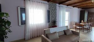 a living room with a couch and a table at Phoenice's apartment in Finiq