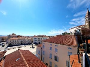 an aerial view of a city with buildings and a clock tower at Akvatour Apartments Piran in Piran