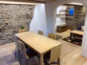 a dining room with a wooden table and chairs at Cal Potablanc in Canillo