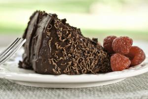a piece of chocolate cake with raspberries on a plate at Golden Stage Inn in Proctorsville
