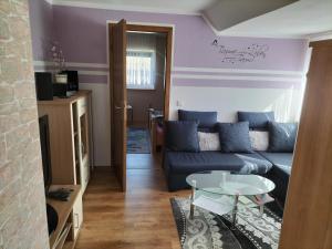 a living room with a couch and a table at FeWo Zur Alten Drechslerei in Freital
