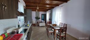 a kitchen and dining room with a table and chairs at Phoenice's apartment in Finiq