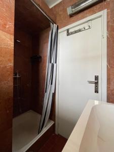 a bathroom with a shower and a white tub at ROOM in Molhe house with pool in Porto