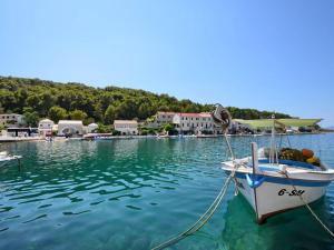 a boat is docked in a body of water at Villa Povlja in Povlja