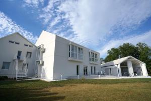 a large white building with a sky in the background at Dom wycieczkowy Zacisze in Sandomierz