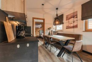 a kitchen and dining room with a table and chairs at Apartment Typ D im Alpin Resort Mo in Gargellen