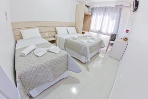 Postel nebo postele na pokoji v ubytování North Hotel - Aeroporto