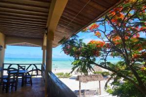 a view of the beach from the porch of a beach house at White Sands in Paje