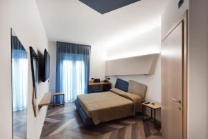 A bed or beds in a room at Color Hotel Rimini