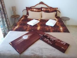 a bedroom with a large bed with a wooden headboard at LUČICE - 2024 - PETROVAC, Prijevorac, BB - Apartment - OXANA - Stan 1 in Petrovac na Moru