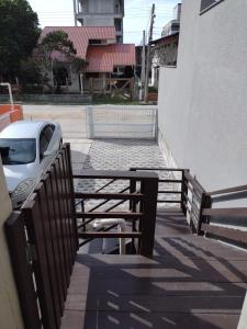 a car parked next to a fence next to a building at APARTAMENTO MARISCAL in Bombinhas