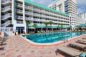 a swimming pool in front of a large building at Daytona Beach Resort Unit #302 in Daytona Beach
