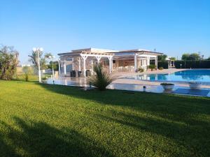 a house with a swimming pool and a yard at Agriturismo Li Damiani in Otranto