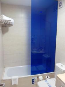 a bathroom with a glass shower with a toilet and a sink at Hotel Moon in A Coruña +17 photos