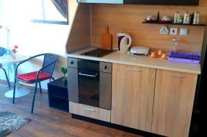 a small kitchen with a stove and a table at Къща за гости Вълчеви Несебър in Nesebar