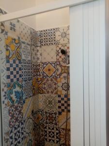 a bathroom with colorful tiles on the wall at GRomano Apartments in Ischia