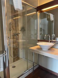 a bathroom with a glass shower and a sink at Chambre d'hôtes Hôte des Portes Île de Ré in Les Portes