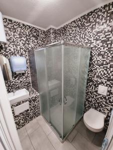 a bathroom with a shower and a toilet at Hostel BellaVista in Koper